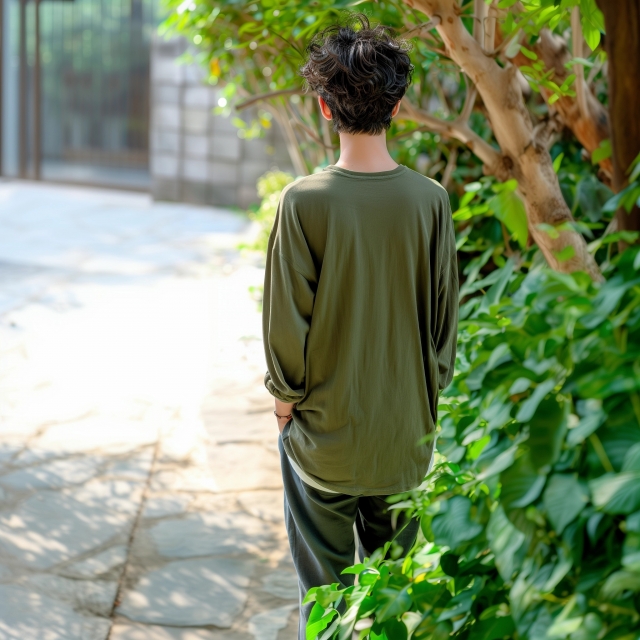 背を向けて歩いていく若い男性の後ろ姿